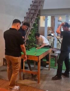 Pengunjung bermain mini billiard di Transitory Coffee Depok, menambah pilihan aktivitas santai selain menikmati sajian kopi. Foto: Harnas.id